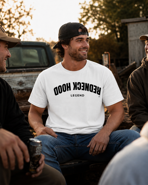 White Inverted T-shirt with upside-down Redneck Hood lettering, outdoor view